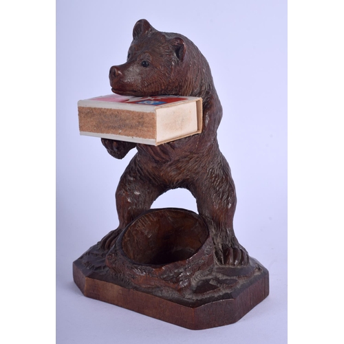 323 - AN ANTIQUE BAVARIAN BLACK FOREST CARVED WOOD BEAR modelled as smoker compendium. 17 cm high.