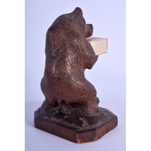 323 - AN ANTIQUE BAVARIAN BLACK FOREST CARVED WOOD BEAR modelled as smoker compendium. 17 cm high.