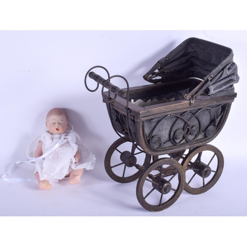 346 - A VINTAGE FOLK ART TYPE CHILDS DOLLS PRAM containing a European bisque doll stamped W. Pram 24 cm x ... 