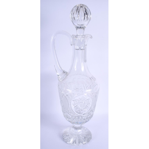 41 - A VERY LARGE CRYSTAL CUT GLASS DECANTER AND STOPPER decorated with star shaped motifs. 57 cm x 20 cm... 