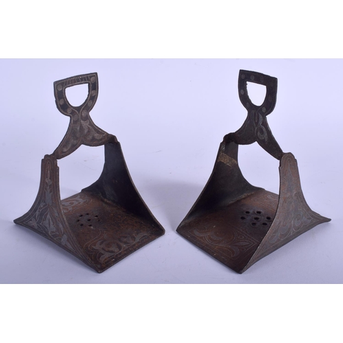 739 - A PAIR OF 19TH CENTURY SILVER INLAID IRON STIRRUPS decorated with foliage. 16 cm x 11 cm.