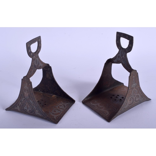 739 - A PAIR OF 19TH CENTURY SILVER INLAID IRON STIRRUPS decorated with foliage. 16 cm x 11 cm.