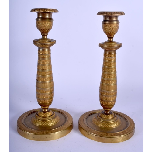 745 - A PAIR OF 19TH CENTURY FRENCH EMPIRE GILT METAL CANDLESTICKS decorated with a flower banding. 23 cm ... 