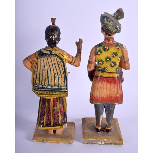 749 - A PAIR OF MIDDLE EASTERN ANTIQUE INDIAN RAJASTHAN PAINTED WOOD FIGURES. 20 cm high.