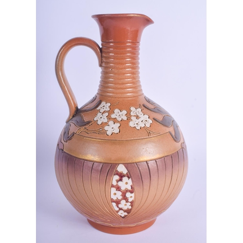 76 - A 19TH CENTURY FRENCH SARREGUEMINES STONEWARE JUG decorated with floral sprays. 23.5 cm high.