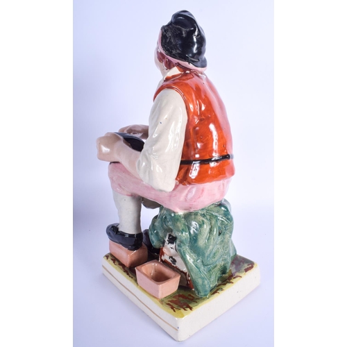 85 - A 19TH CENTURY CONTINENTAL STAFFORDSHIRE TYPE FIGURE OF THE COBBLER modelled upon a square base. 33 ... 