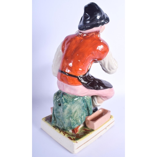 85 - A 19TH CENTURY CONTINENTAL STAFFORDSHIRE TYPE FIGURE OF THE COBBLER modelled upon a square base. 33 ... 