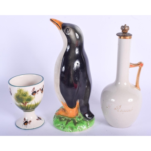 91 - A SCOTTISH WEMYSS TYPE G HILL POTTERY EGG CUP together with a penguin etc. Largest 13.5 cm high. (3)