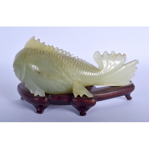 1296 - A LARGE EARLY 20TH CENTURY CHINESE CARVED JADE FIGURE OF A FISH Late Qing, modelled upon a fitted ha... 