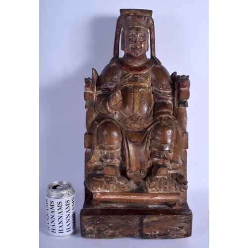 1310 - A LARGE EARLY CHINESE POLYCHROMED WOOD FIGURE OF A SEATED SCHOLAR Late Ming/Qing, modelled holding a... 