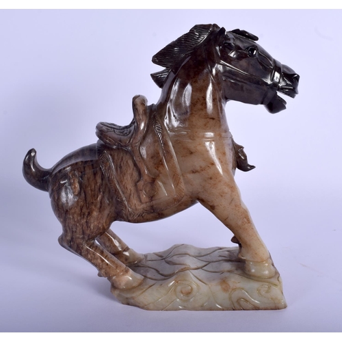 1311 - AN EARLY 20TH CHINESE CARVED JADE FIGURE OF A HORSE modelled upon a naturalistic base. 21 cm x 21 cm... 