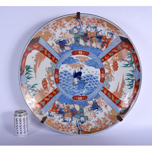 1322 - A VERY LARGE 19TH CENTURY JAPANESE MEIJI PERIOD IMARI CHARGER painted with boys within landscapes. 4... 