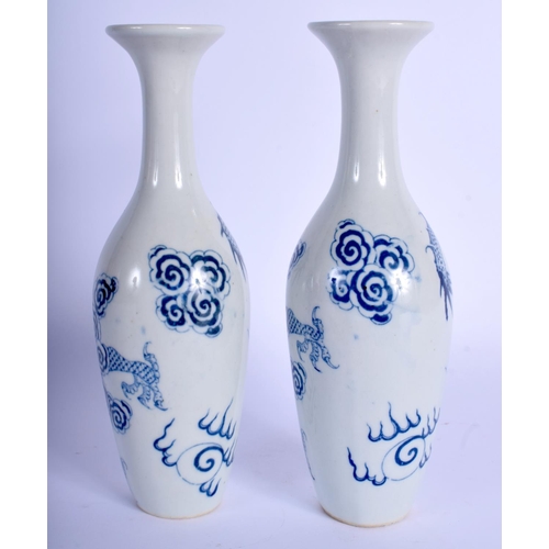 1324 - A PAIR OF CHINESE BLUE AND WHITE PORCELAIN VASES 20th Century, decorated with dragons amongst clouds... 