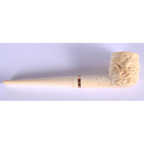 1639 - AN EARLY 20TH CHINESE CANTON IVORY PIPE Qing, modelled with a dragon terminal. 15 cm wide.