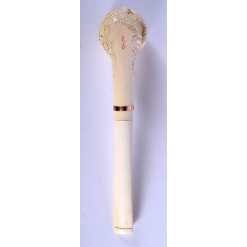 1639 - AN EARLY 20TH CHINESE CANTON IVORY PIPE Qing, modelled with a dragon terminal. 15 cm wide.