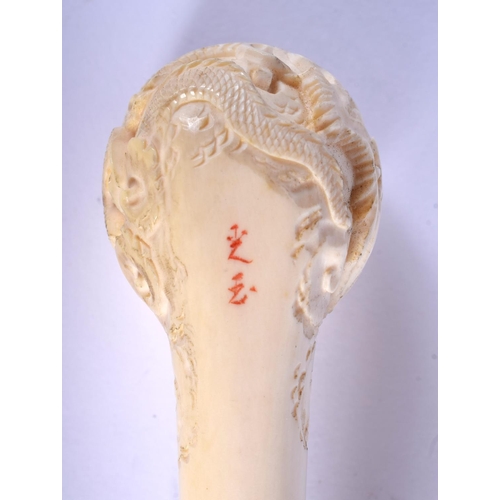 1639 - AN EARLY 20TH CHINESE CANTON IVORY PIPE Qing, modelled with a dragon terminal. 15 cm wide.