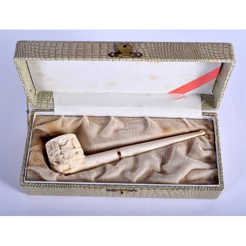 1639 - AN EARLY 20TH CHINESE CANTON IVORY PIPE Qing, modelled with a dragon terminal. 15 cm wide.