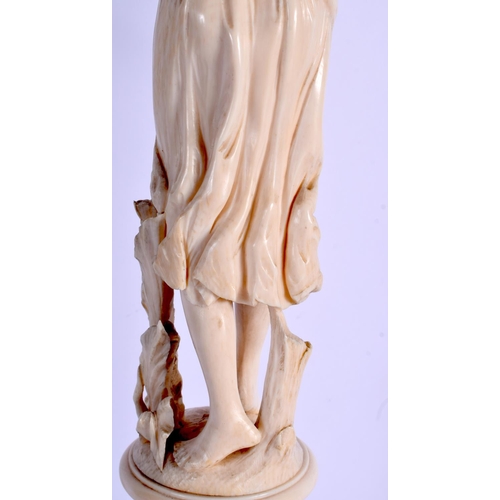 2351 - A VERY LARGE 19TH CENTURY EUROPEAN CARVED IVORY FIGURE OF A FEMALE modelled with one arm raised upon... 