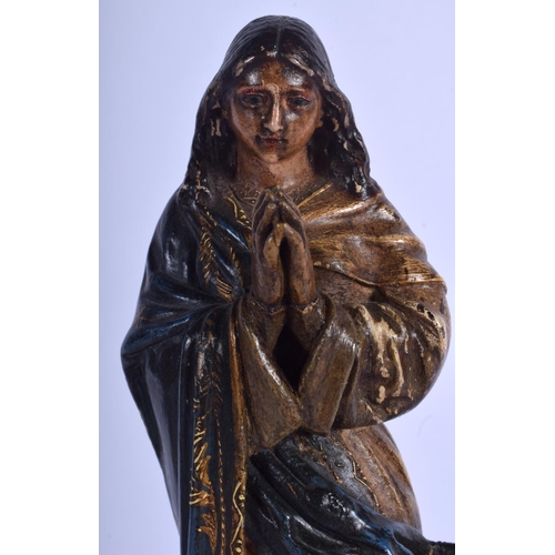 2352 - A LARGE 18TH CENTURY SOUTHERN EUROPEAN CARVED POLYCHROMED WOOD SAINT upon a velvet base. 33 cm high.