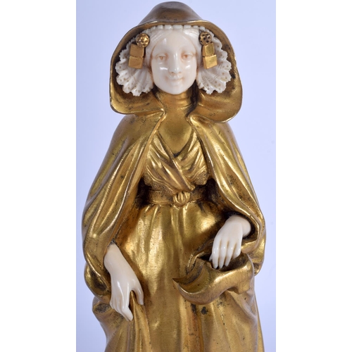 2353 - A 19TH CENTURY FRENCH ART NOUVEAU GILT BRONZE AND IVORY FIGURE OF A FEMALE modelled holding a pair o... 