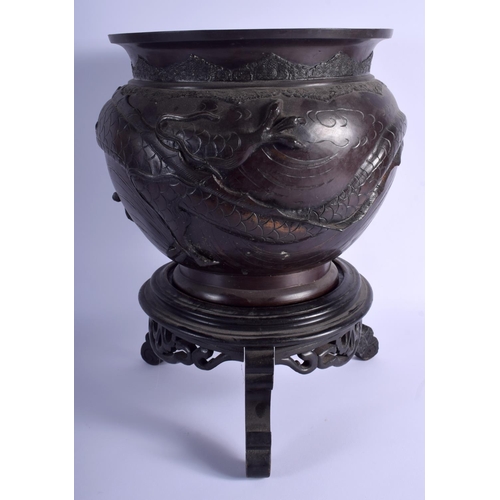 1013 - A 19TH CENTURY JAPANESE MEIJI PERIOD BRONZE JARDINIERE decorated with dragons. 27 cm x 21 cm.