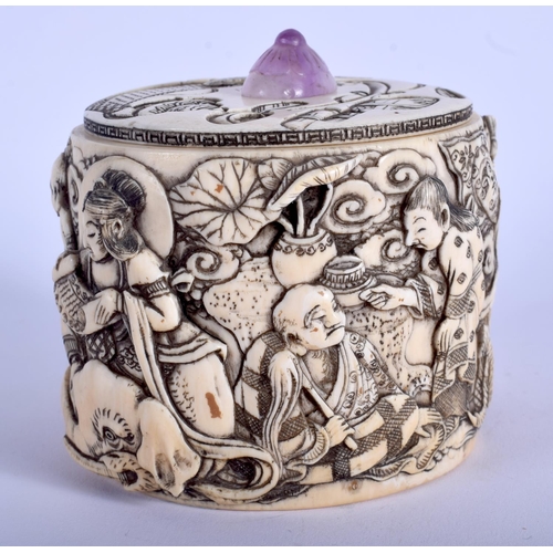 1028 - A 19TH CENTURY JAPANESE MEIJI PERIOD CARVED IVORY BOX AND COVER with amethyst finial, decorated with... 