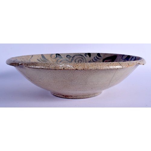 1037 - AN 18TH CENTURY CHINESE VIETNAMESE BLUE AND WHITE STONEWARE BOWL painted with  swirling motifs. 32 c... 