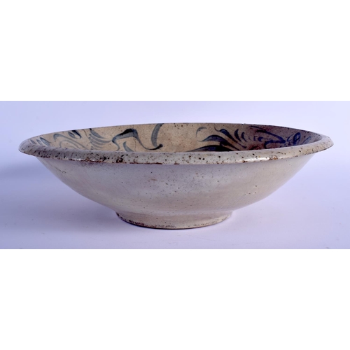 1037 - AN 18TH CENTURY CHINESE VIETNAMESE BLUE AND WHITE STONEWARE BOWL painted with  swirling motifs. 32 c... 