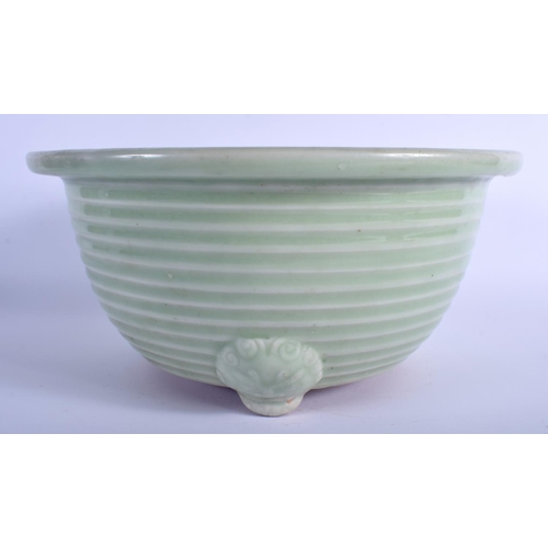 1040 - A LARGE 19TH CENTURY CHINESE CELADON RIBBED CENSER Qing, with highly unusual mask head mounts. 26 cm... 