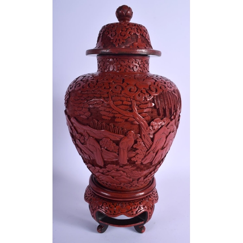 1045 - A RARE 19TH CENTURY CHINESE CARVED CINNABAR LACQUER VASE AND COVER Qing, upon a fitted stand. 37 cm ... 