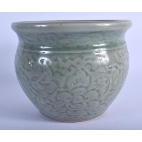 1069 - A 19TH CENTURY CHINESE CELADON POTTERY JARDINIERE decorated with foliage and vines. 13 cm x 16 cm.