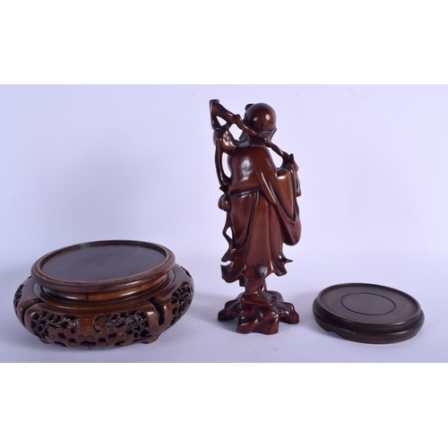 1087 - A 19TH CENTURY CHINESE CARVED HARDWOOD FIGURE OF AN IMMORTAL together with two stands. (3)