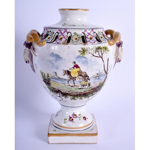 111 - AN 18TH CENTURY FRENCH FAIENCE POTTERY URN painted with figures and landscapes. 20 cm high.