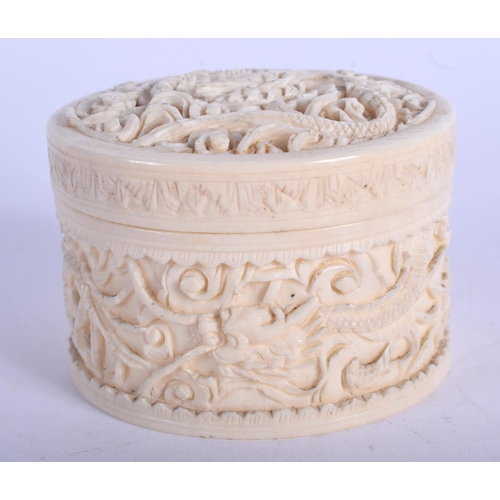 1163 - A 19TH CENTURY CHINESE CARVED CANTON IVORY BOX AND COVER Qing, decorated with dragons. 6.5 cm diamet... 