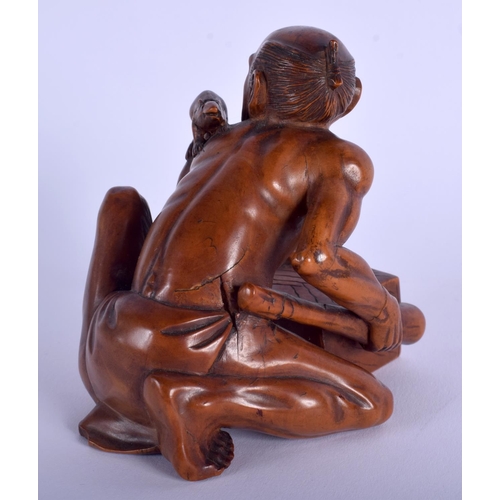 1177 - A 19TH CENTURY JAPANESE MEIJI PERIOD CARVED BOXWOOD RAT CATCHER modelled scowling upon an upturned b... 