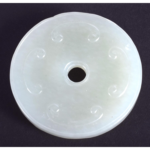 1249 - AN EARLY 20TH CENTURY CHINESE CARVED GREEN JADE CHILONG DISC Late Qing/Republic. 4.25 cm diameter.