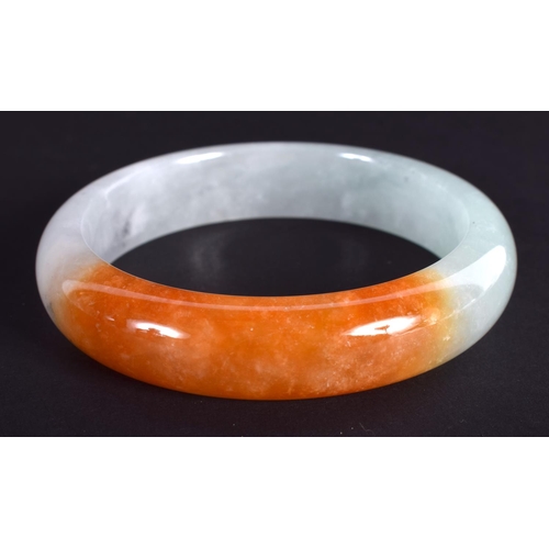 1282 - A CHINESE CARVED TRI COLOUR JADEITE BANGLE 20th Century. 7 cm diameter.