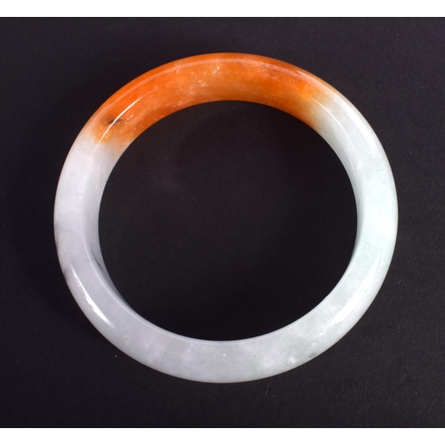 1282 - A CHINESE CARVED TRI COLOUR JADEITE BANGLE 20th Century. 7 cm diameter.