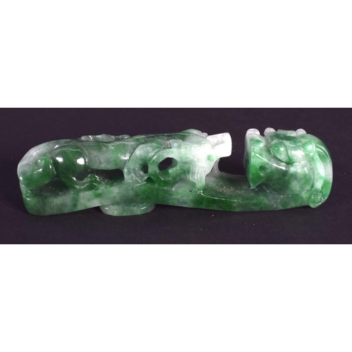 1296 - A CHINESE CARVED GREEN JADEITE BELT HOOK 20th Century. 6.5 cm long.