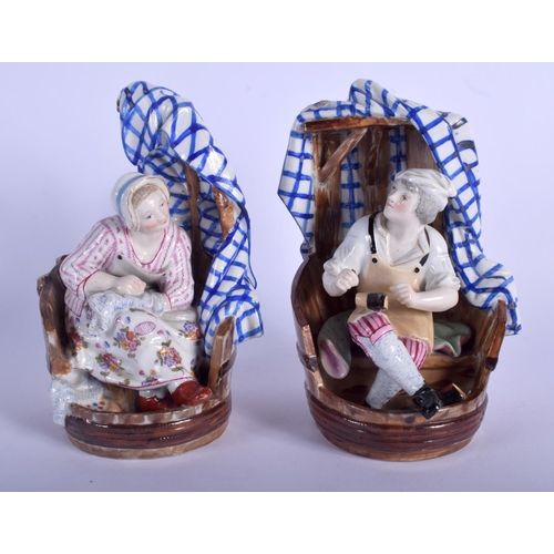 132 - A PAIR OF 19TH CENTURY CONTINENTAL PORCELAIN FIGURES modelled as a male and female within chairs. 19... 