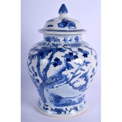 1334 - A 19TH CENTURY CHINESE BLUE AND WHITE VASE AND COVER bearing Qianlong marks to base. 23.5 cm high.