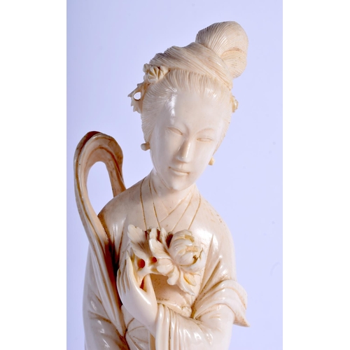 1370 - AN EARLY 20TH CENTURY CHINESE CARVED IVORY FIGURE OF A FEMALE Late Qing. Ivory 24.5 cm high.