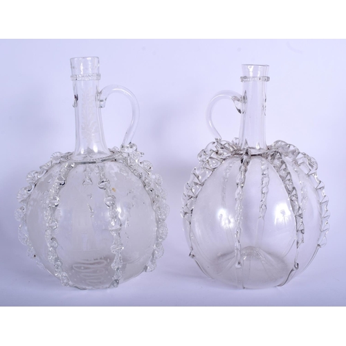 14 - AN UNUSUAL PAIR OF ANTIQUE CONTINENTAL GLASS JUGS of bulbous form with rippled bodies. 24.5 cm high.