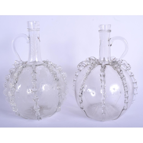 14 - AN UNUSUAL PAIR OF ANTIQUE CONTINENTAL GLASS JUGS of bulbous form with rippled bodies. 24.5 cm high.