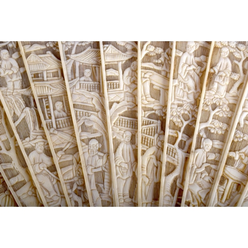 1400 - A MID 19TH CENTURY CHINESE CANTON CARVED IVORY FAN Qing, decorated with figures in various pursuits.... 