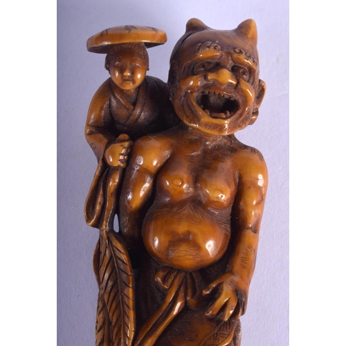 1415 - A LARGE 19TH CENTURY JAPANESE MEIJI PERIOD STAINED IVORY NETSUKE modelled as oni with a farmer upon ... 