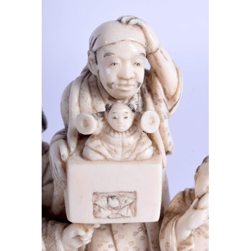 1423 - A GOOD 19TH CENTURY JAPANESE MEIJI PERIOD CARVED IVORY STREET ENTERTAINER modelled with attendants. ... 