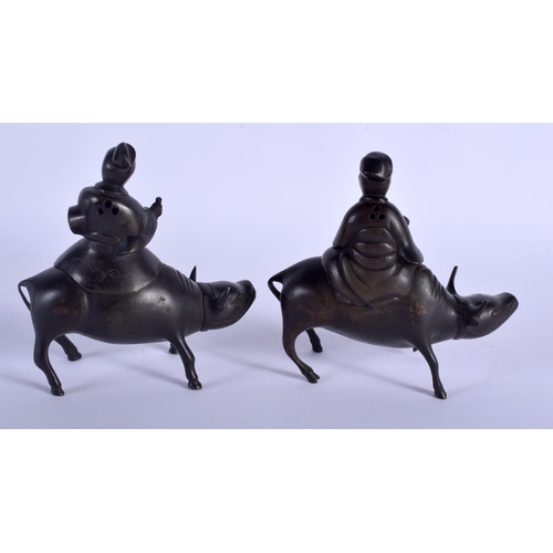 1439 - A PAIR OF 19TH CENTURY CHINESE SILVER INLAID BRONZE FIGURES modelled as scholars upon buffalos. 15 c... 