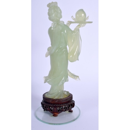 1449 - AN EARLY 20TH CENTURY CHINESE CARVED JADE FIGURE OF GUANYIN modelled holding aloft a fruit. Jade 15 ... 