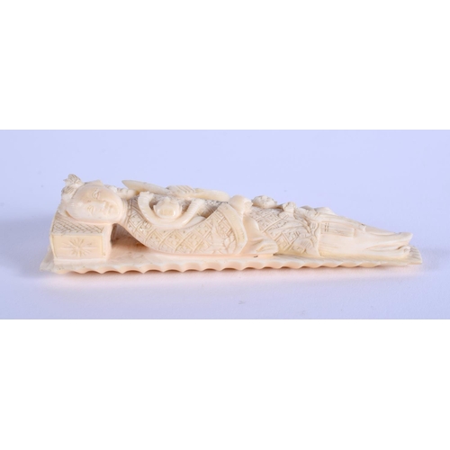 1451 - A RARE 19TH CENTURY CHINESE CARVED IVORY MEDICINE DOLL modelled as a reclining female upon a leaf. 9... 